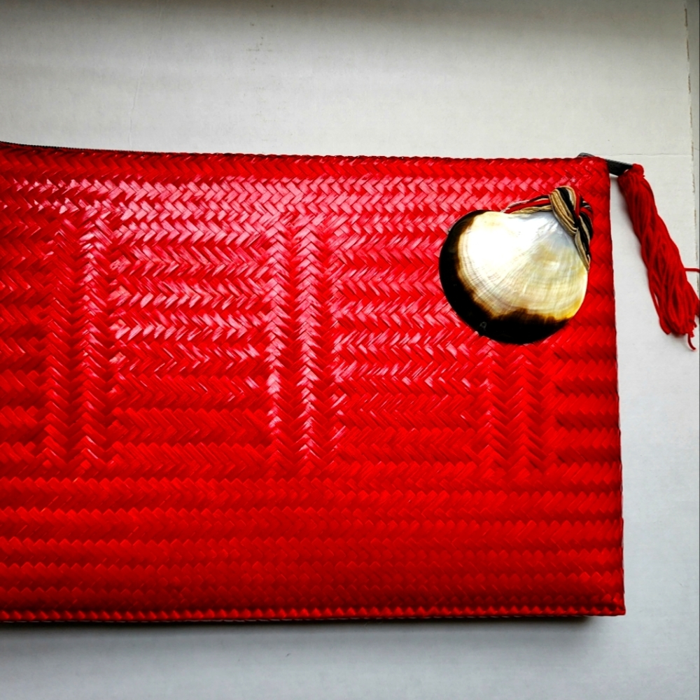 Red woven wicker with intricate shell woven onto clutch